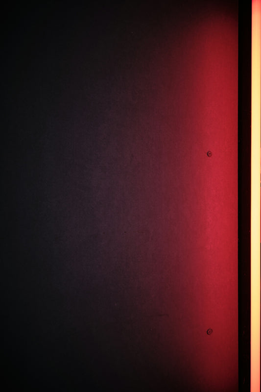 a dark room with a red light on the wall